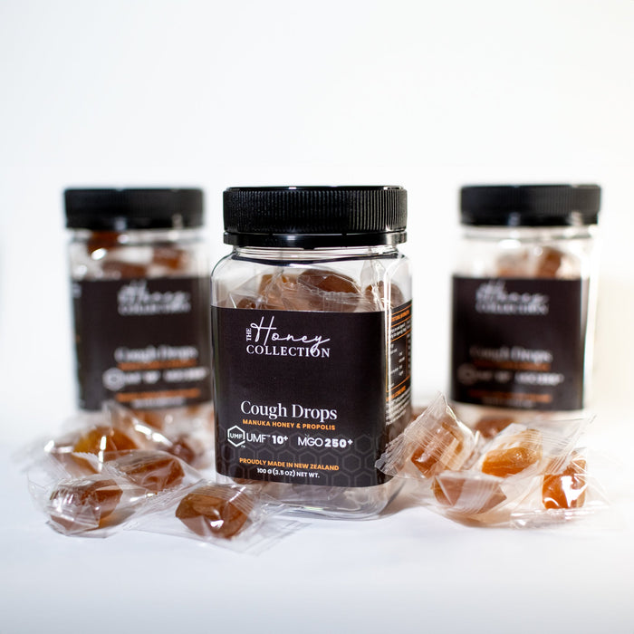 Manuka honey and propolis cough drops from The Honey Collection, showing the honey-flavored lozenges in a natural setting