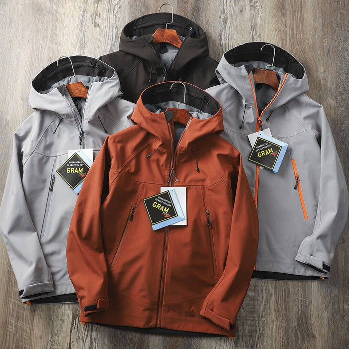 Men's waterproof softshell jacket by Mead's Supply & Equipment Outfitters, windproof hooded hiking shell for outdoor protection.