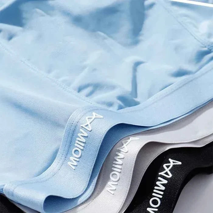 Three pairs of men's breathable boxer shorts from MiiOW, featuring comfortable, lightweight fabric in neutral colors.