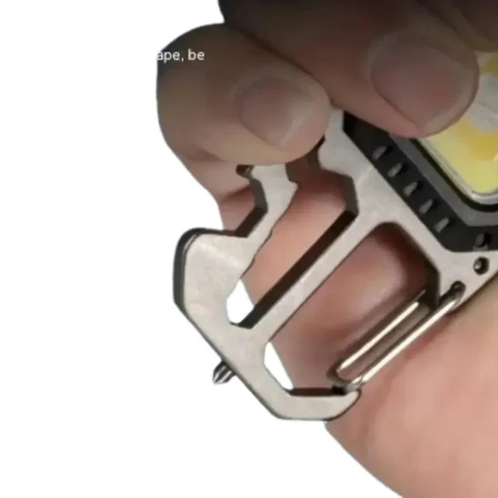 Mini LED keychain flashlight in silver with compact design and bright light, branded by Habicare.