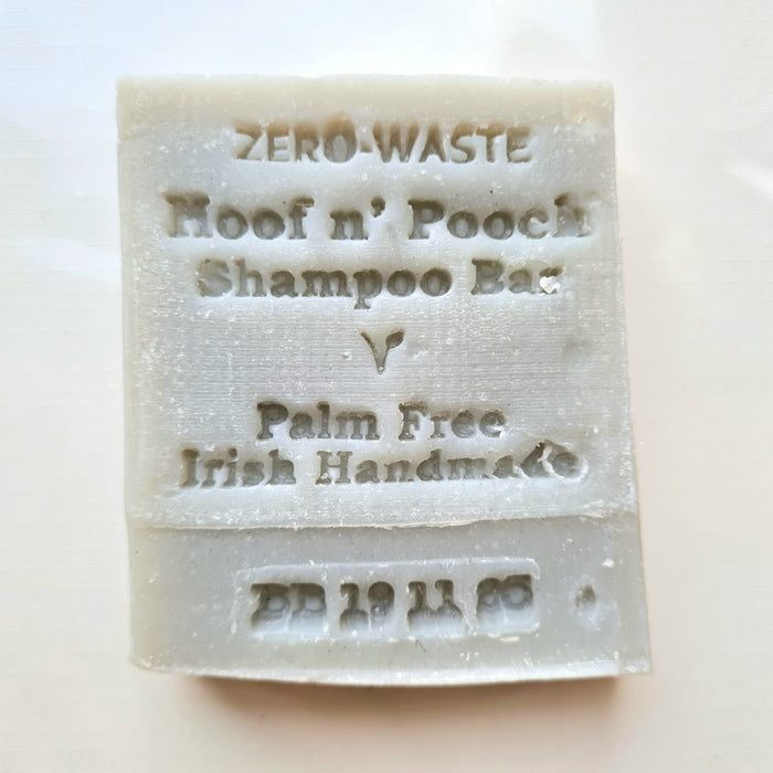 A white, solid-colored pet shampoo bar with 'ZERO WASTE' and 'For Hoof & Pouch' printed on it, indicating that it is palm free and made in Ireland.
