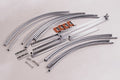 Set of metal hardware parts including curved tubes, clamps, and connectors for DIY projects.