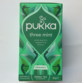 A box of Pukka Three Mint herbal tea with illustrations of mint leaves and the text highlighting pure spearmint, peppermint, and field mint.