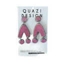 Pink earrings on a Quazi Design branded card
