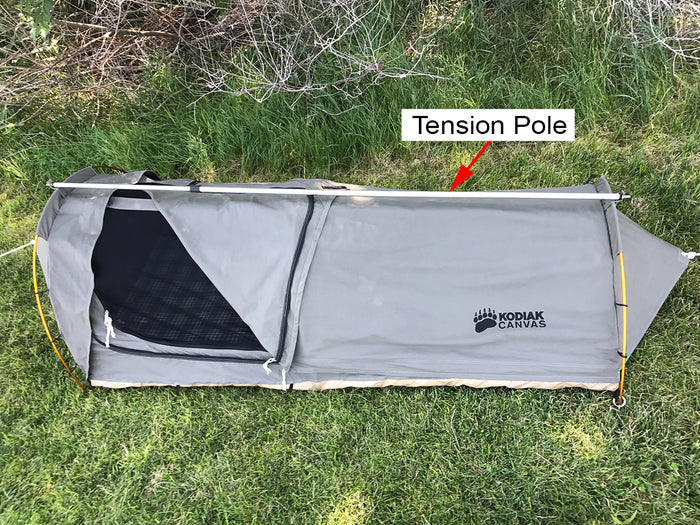 Kodiak Canvas tent featuring a gray color, durable material, and tension pole for stability and support.