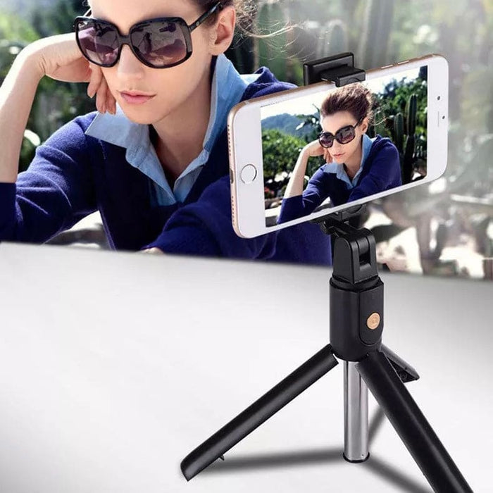 9eight5 selfie stick with remote and stand for phones and tablets, showing a portable extendable handle with mounted device