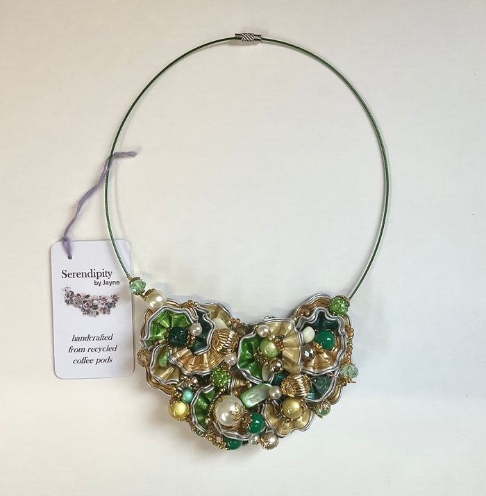 Necklace with green and gold beads on a white background