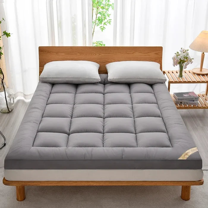 Soft warm autumn winter mattress topper for cozy comfort, featuring plush filling and a smooth fabric cover.