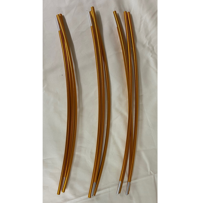 Set of three curved golden metal rods with silver tips on a white background.