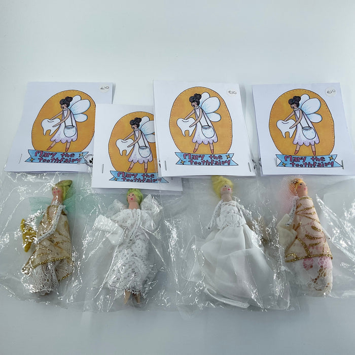 Set of fairy figurines with packaging and tooth fairy cards on a white background