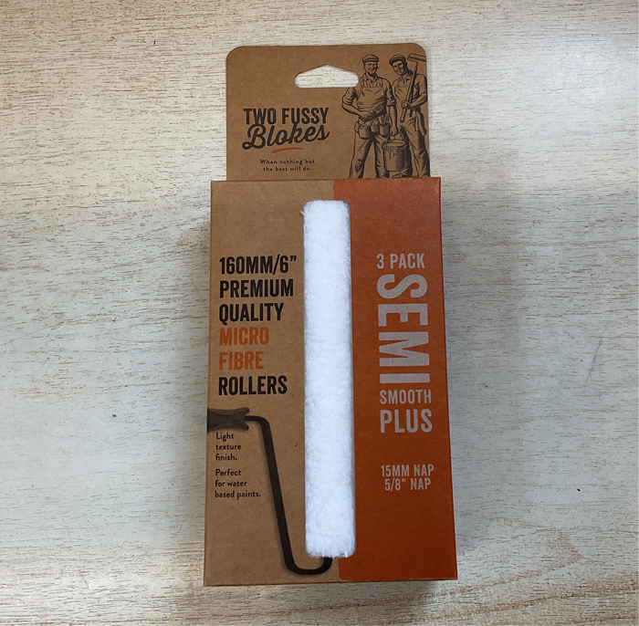 Three-pack of semi-smooth plus microfiber rollers in a cardboard packaging on a wooden surface.