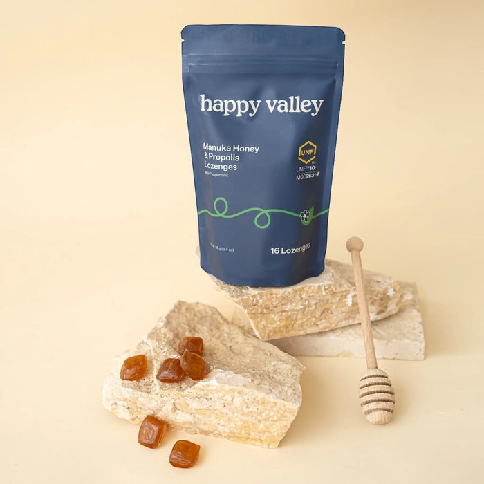 Happy Valley Honey UMF 10+ Manuka Honey and Propolis Peppermint Lozenges in a clear plastic package, with individual lozenge visible.