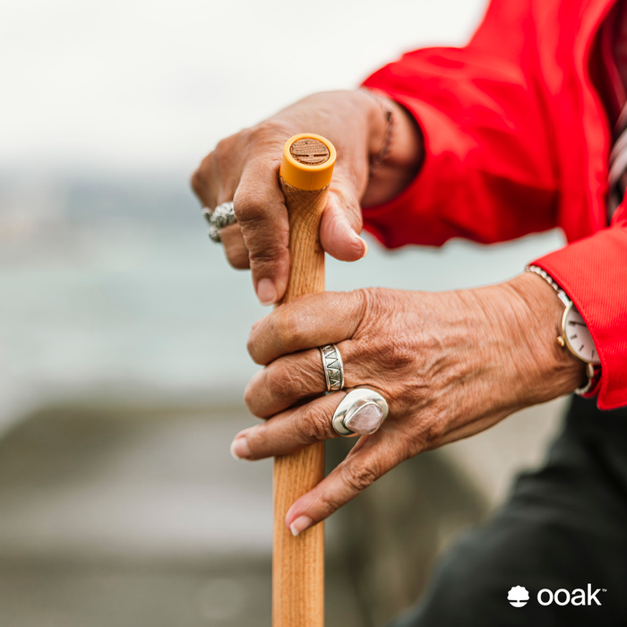 Close-up of Ooak Uno Kōwhai and Oak walking stick with detailed wood grain and handcrafted design.