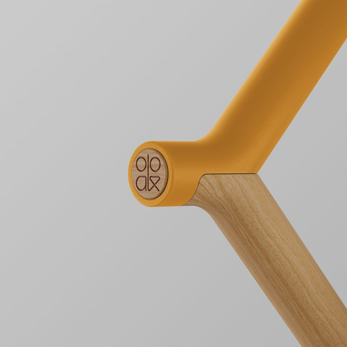 Ooak Uno Kōwhai and Oak walking stick with a logo handle, featuring a natural wood finish and ergonomic design.