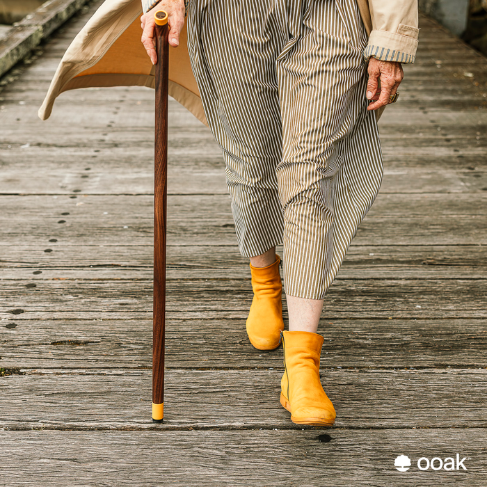 Ooak Uno walking stick featuring Kōwhai and Walnut wood, with a sleek design and smooth finish.