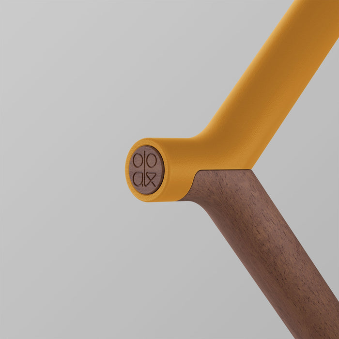 Walking stick with walnut handle and Kōwhai-colored accents by ooak, featuring a natural wood finish and a subtle logo engraving.