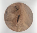 Round plate with a natural grain pattern on a white background