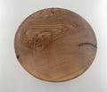 Wooden plate with a natural grain pattern on a white background