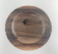 Wooden bowl with a textured rim on a white background