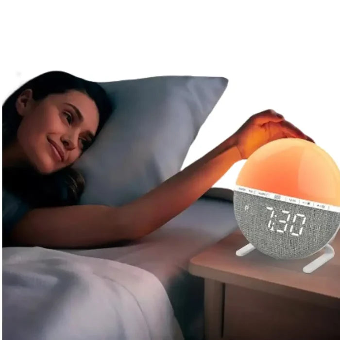 Habicare HBC Wake-Up Light Sunrise Alarm Clock with sunrise simulation and digital display, white design on a bedside table.