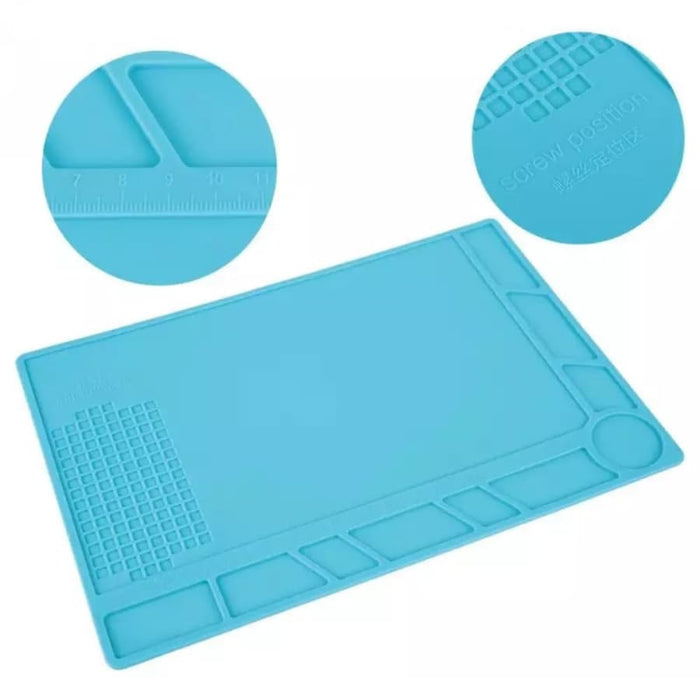 Watch repair mat from That Watch Shop displaying a durable, non-slip surface with watch tools and small components.