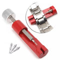 Red watch link remover tool from That Watch Shop, designed for easy adjustment of watch bands and link removal.
