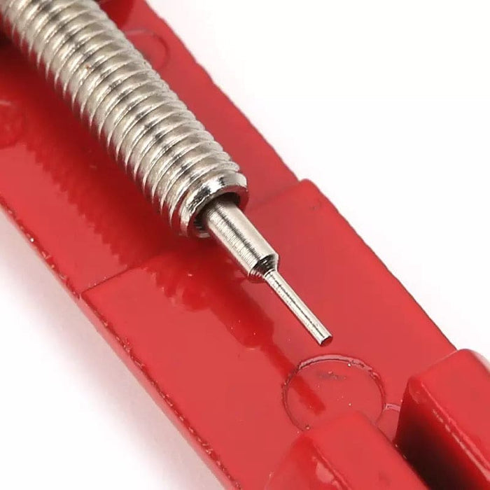 Red watch link remover tool from That Watch Shop, used for adjusting watch band links and resizing watch bracelets.