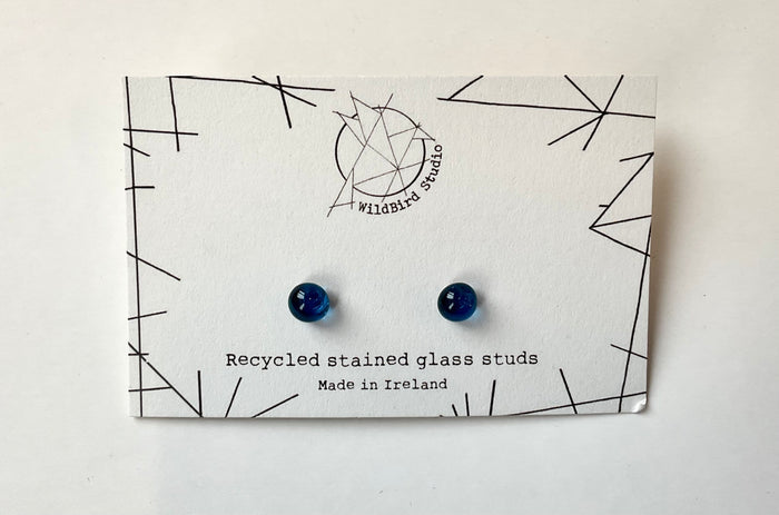 Pair of blue earrings on a WildBird Studio branded card with geometric design