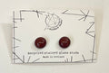 Pair of recycled stained glass earrings on a Wildbird Studio branded paper card.