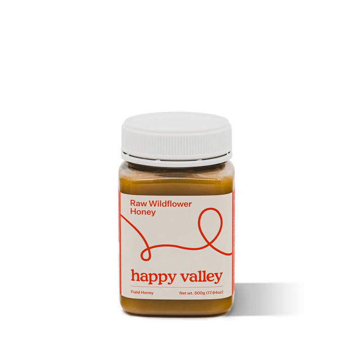 Jar of Happy Valley Honey Wildflower Field Honey, gourmet raw honey with a golden amber color and floral notes.