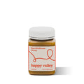 Jar of Happy Valley Honey Wildflower Field Honey, gourmet raw honey with a golden amber color and floral notes.