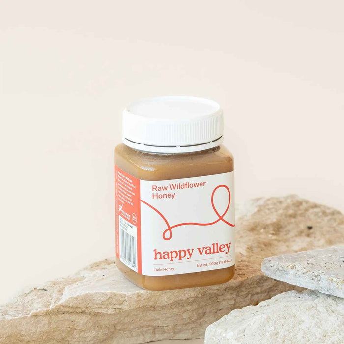 Jar of Wildflower Field Honey from Happy Valley Honey, showcasing raw, gourmet honey with a golden, floral hue and natural texture.