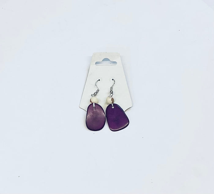 Purple earrings on a white card against a light gray background