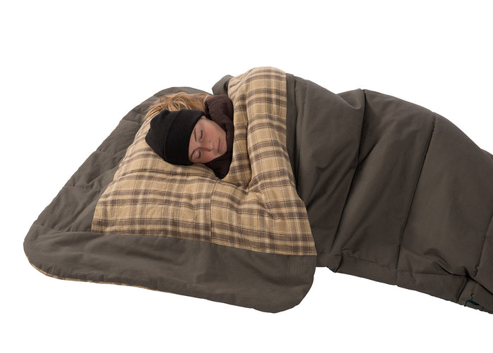 Cozy plaid sleeping bag in brown and beige, perfect for camping with integrated pillow for comfort.