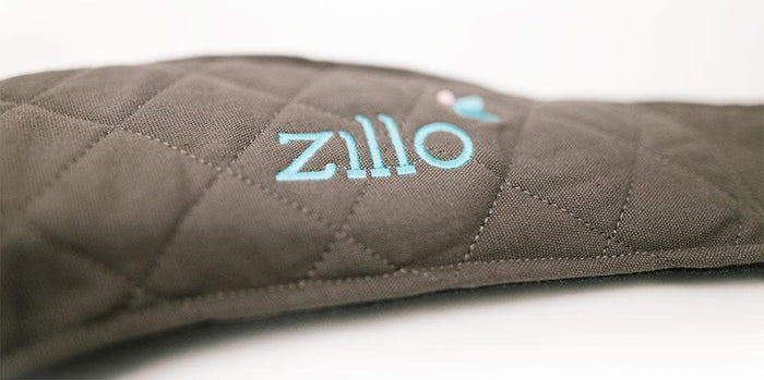 ZilloPillow travel pillow in soft fabric, designed for neck support during travel, shown in a compact, portable form.